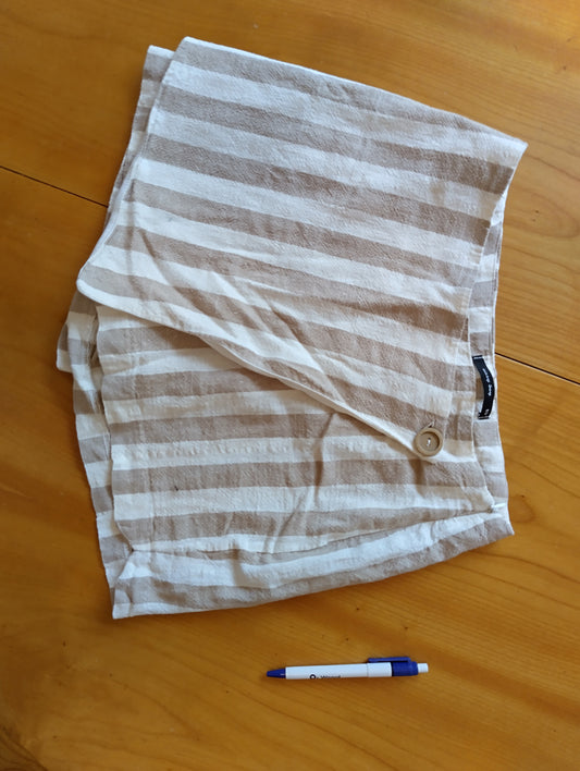 Folded striped linen shorts on a table