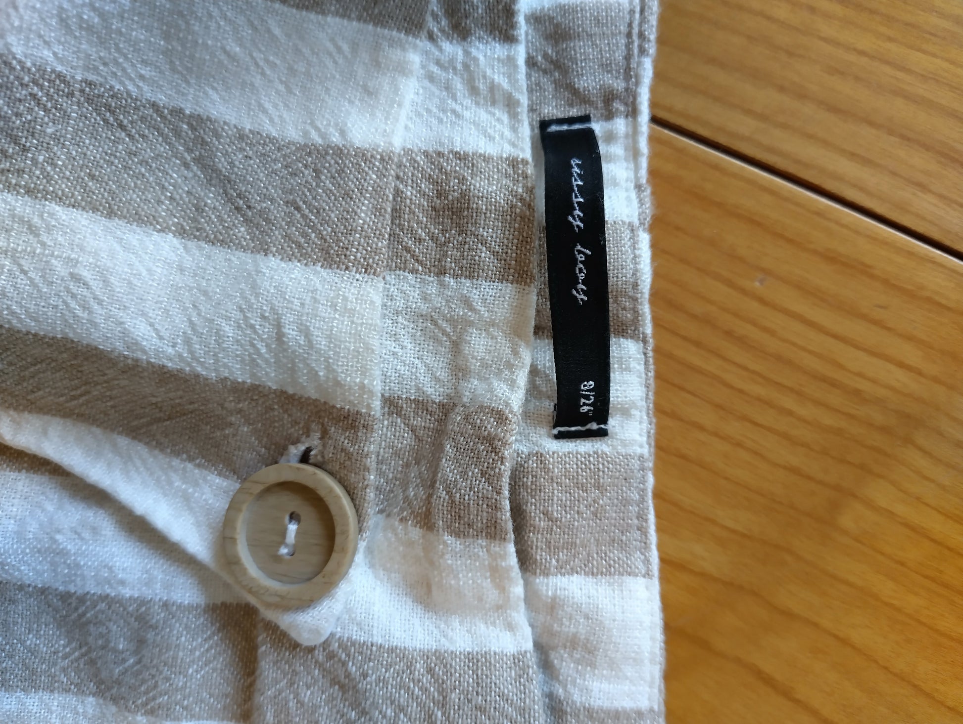 Close-up of the button and tag on the shorts