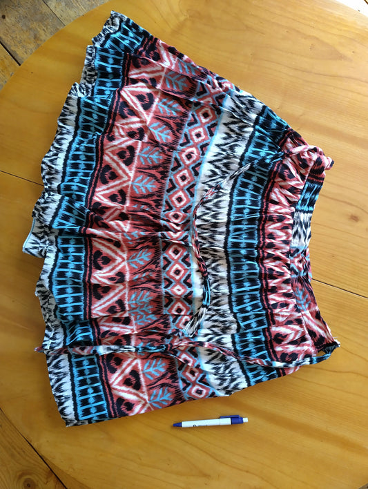 Skater skirt laid out on the table with a pen for size reference