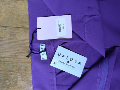 Close-up of tag on purple trousers