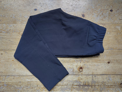 Folded black Costes chinos displaying back pocket