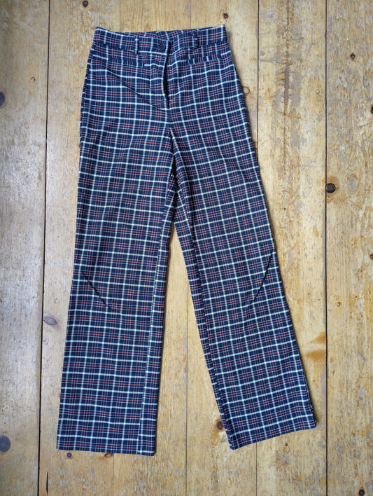 Red plaid straight leg pants on wooden floor