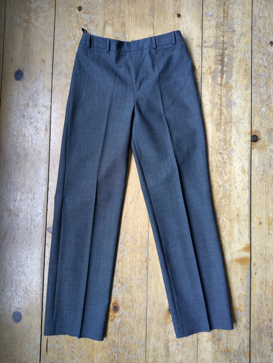 Pair of grey tailored pants on wooden floor