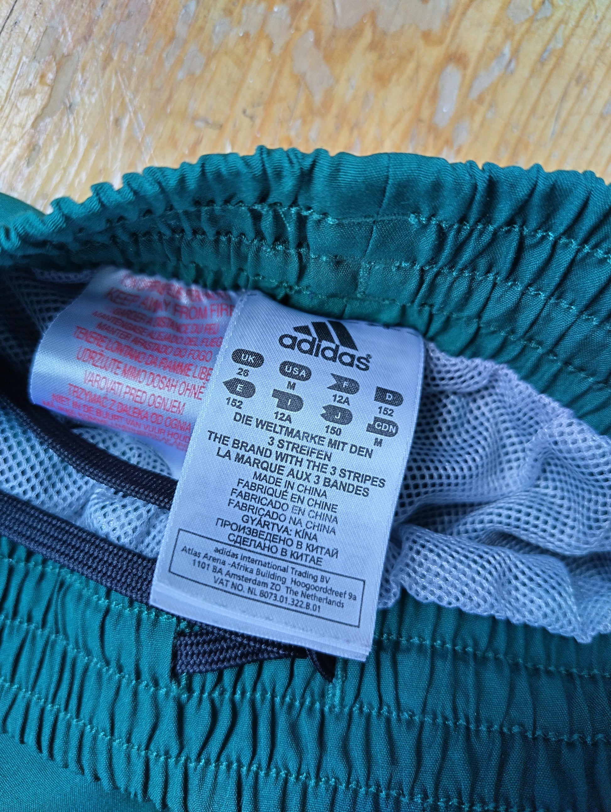 Size and brand label inside the Adidas track pants