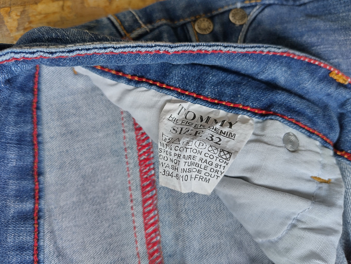 Care label showing size and material of jeans