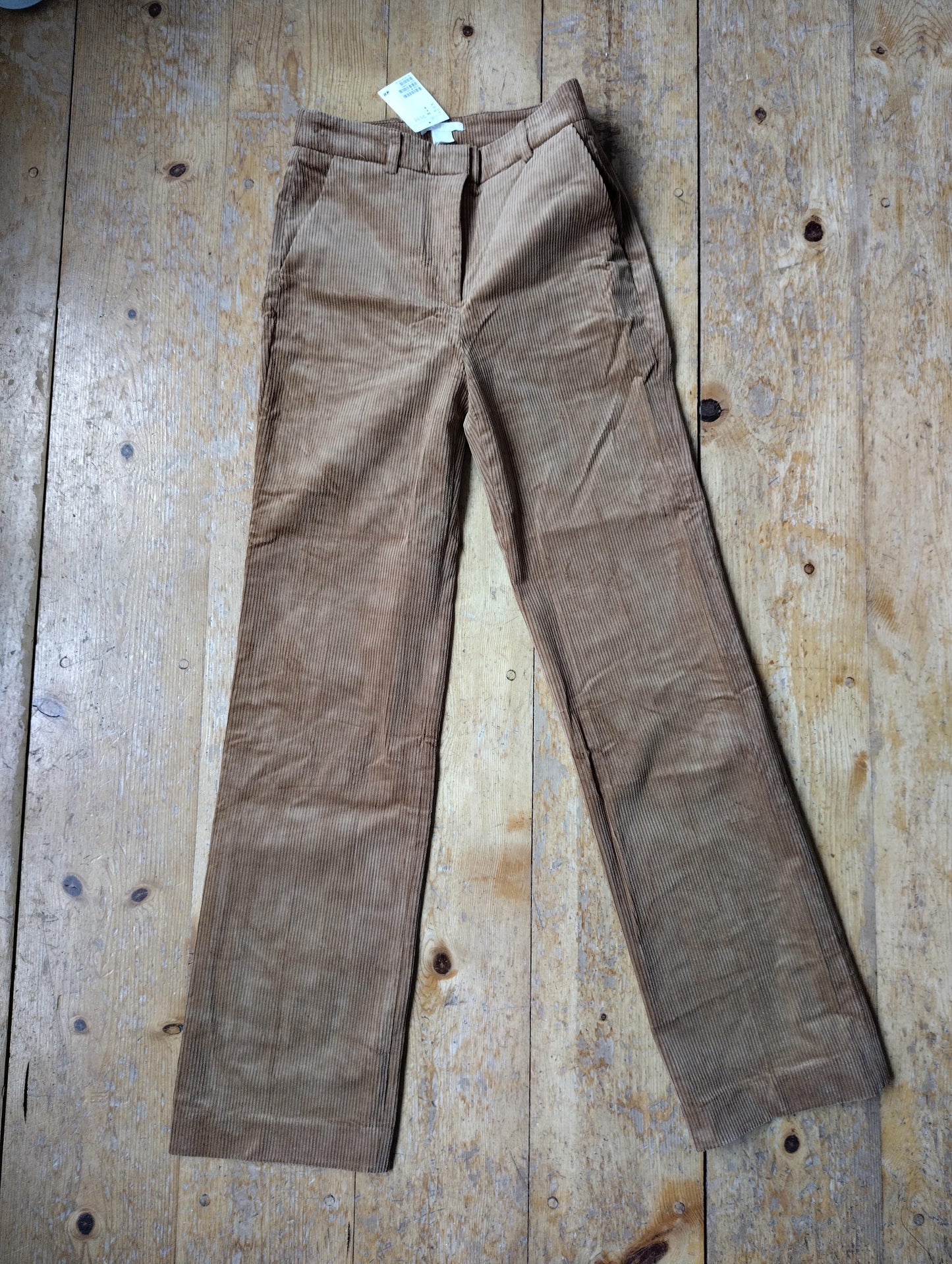 Alternate front view of tan corduroy trousers
