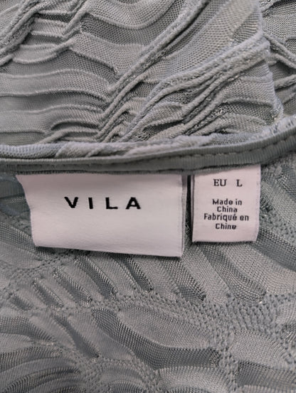 Close-up of Vila brand label on sage green blouse