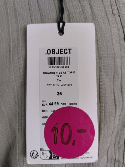 Close-up of Object brand tag on green blouse