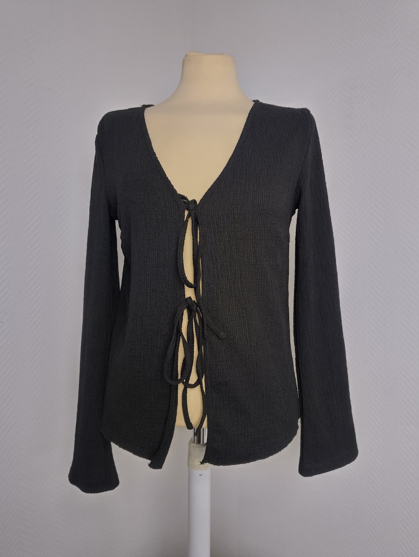 Black long sleeve top on mannequin