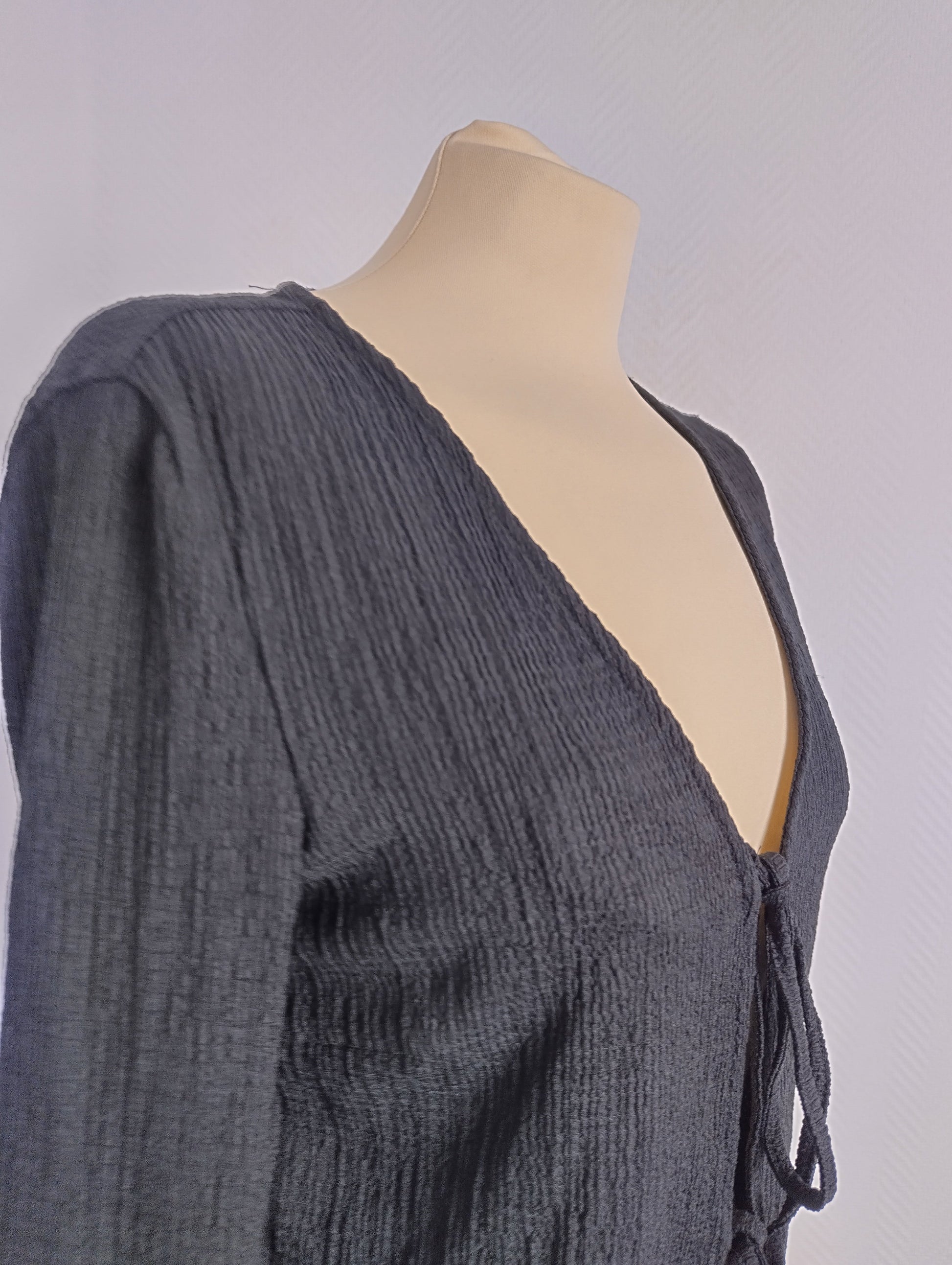 Side view of black long sleeve top