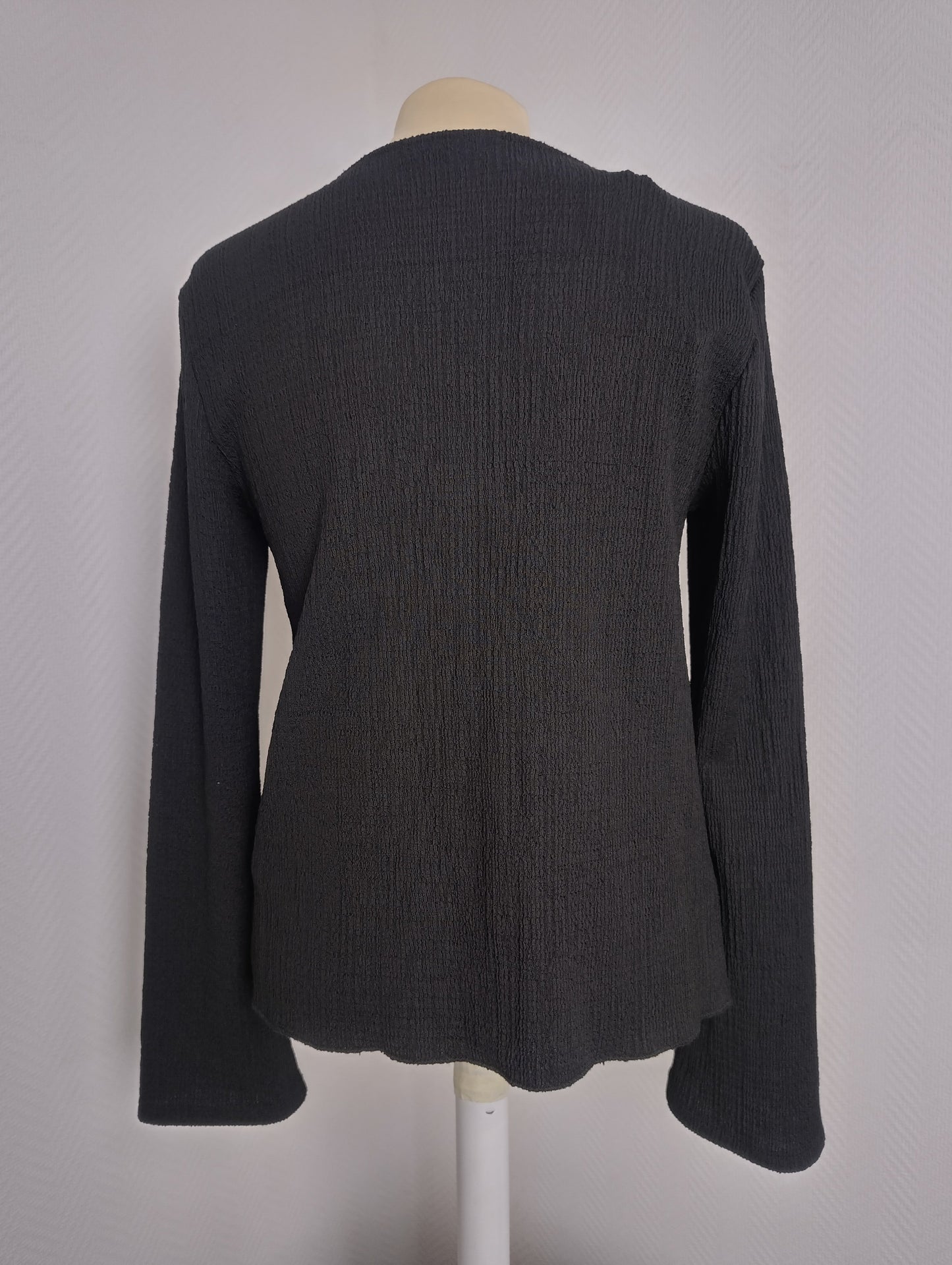 Back view of black long sleeve top