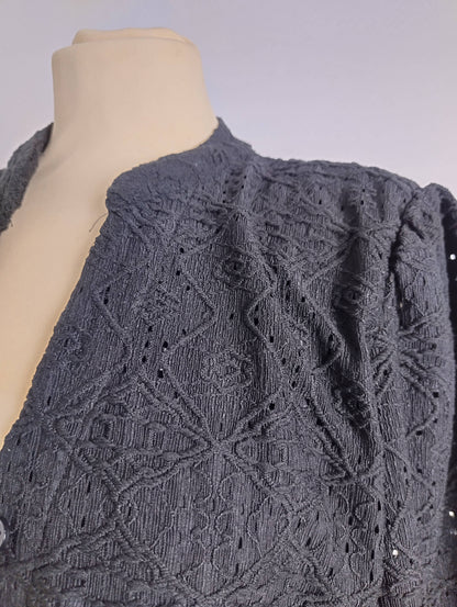 Close-up of embroidered detail on shirt