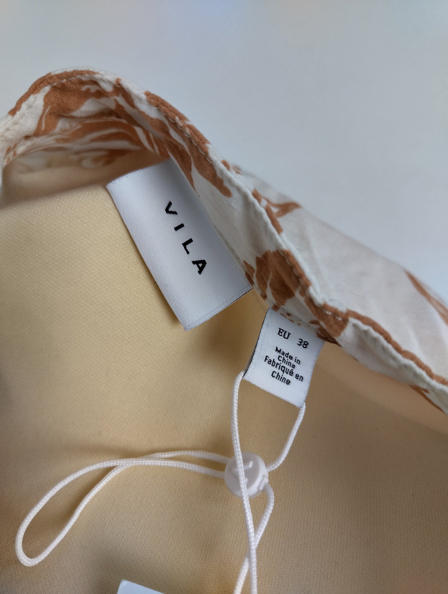 Brand label on brown floral dress