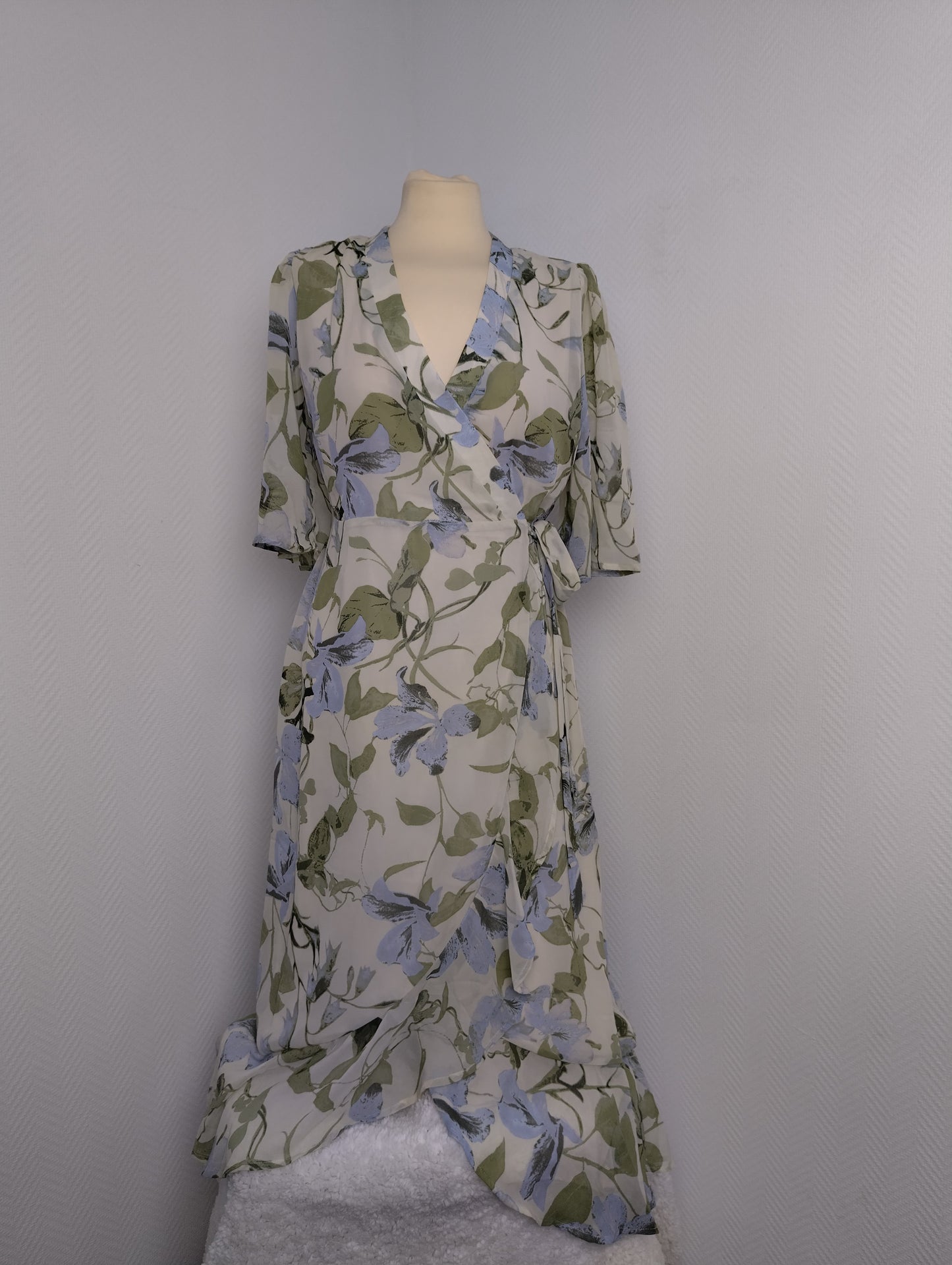 Floral wrap dress on mannequin from the front