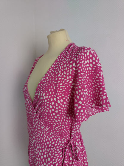Side view close-up of pink polka dot wrap dress by Vila