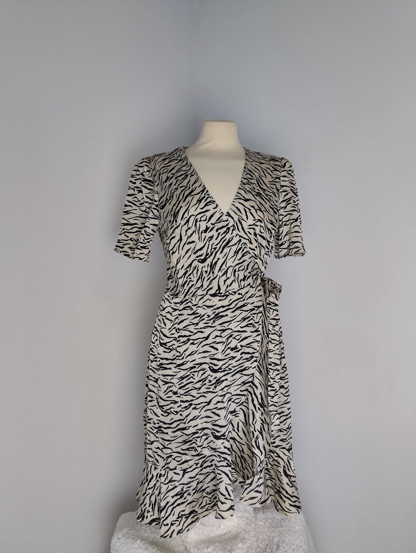Front view of black and white zebra print wrap dress