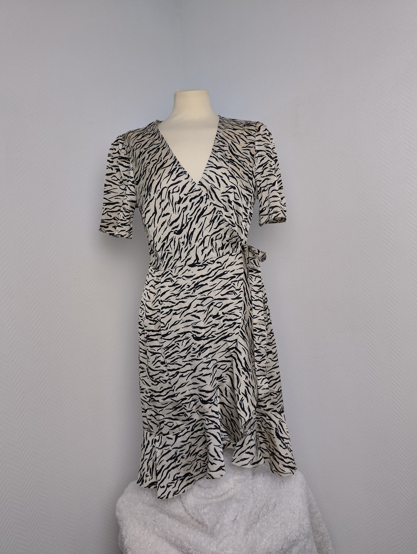 Side view of black and white zebra print wrap dress
