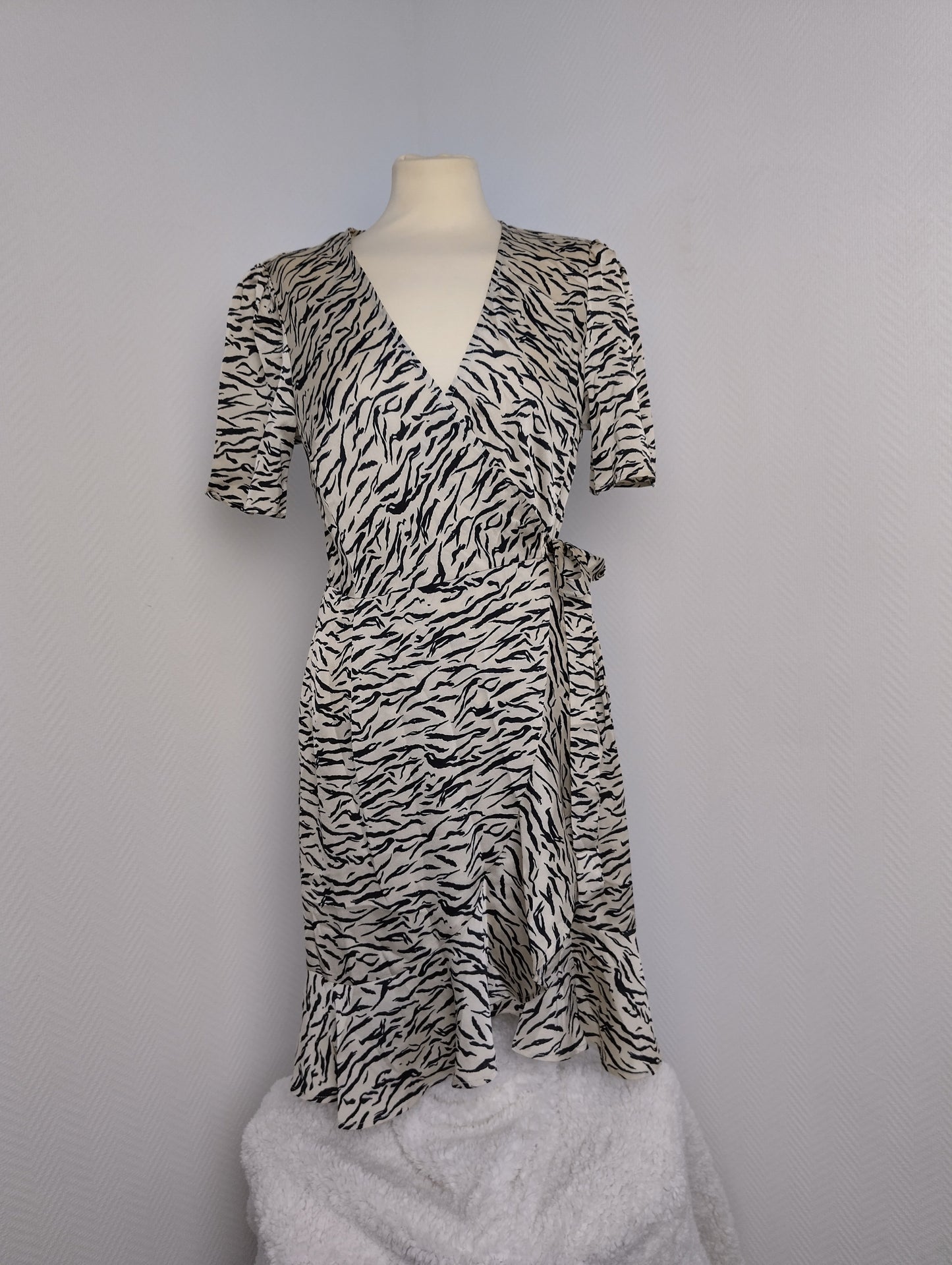 Front view showing wrap design of zebra print dress