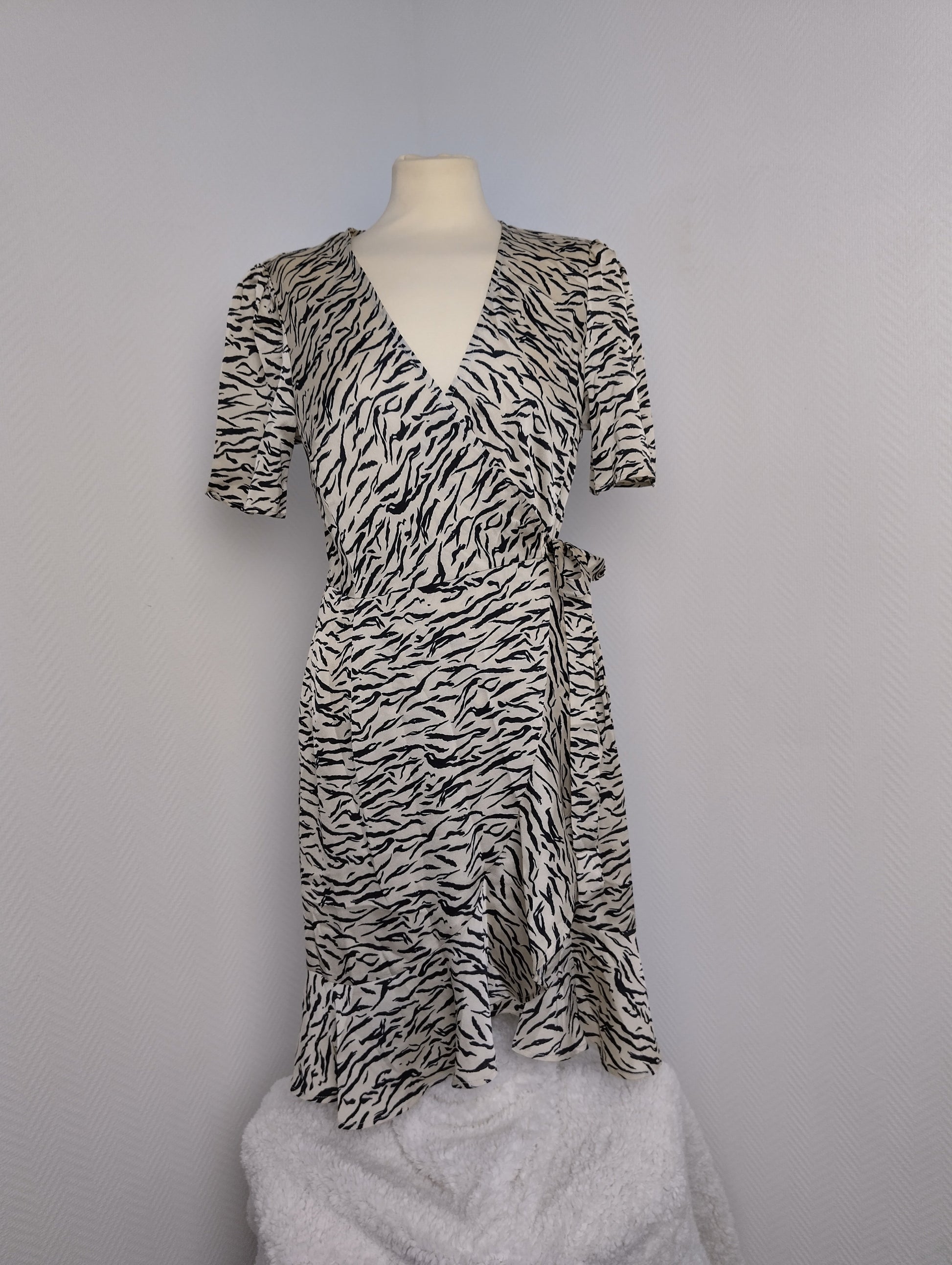Front view showing wrap design of zebra print dress