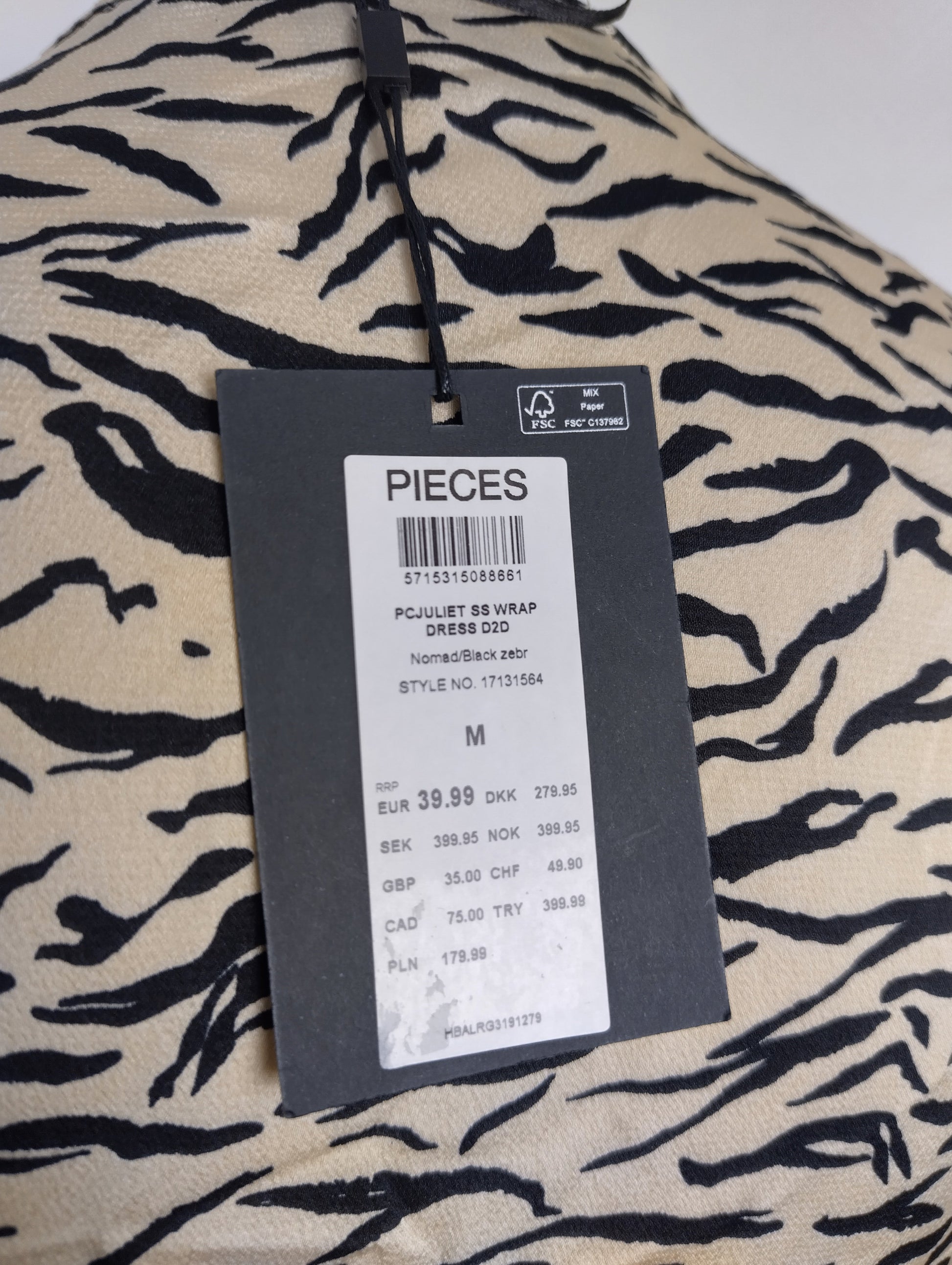 Tag showing price and brand of zebra print dress