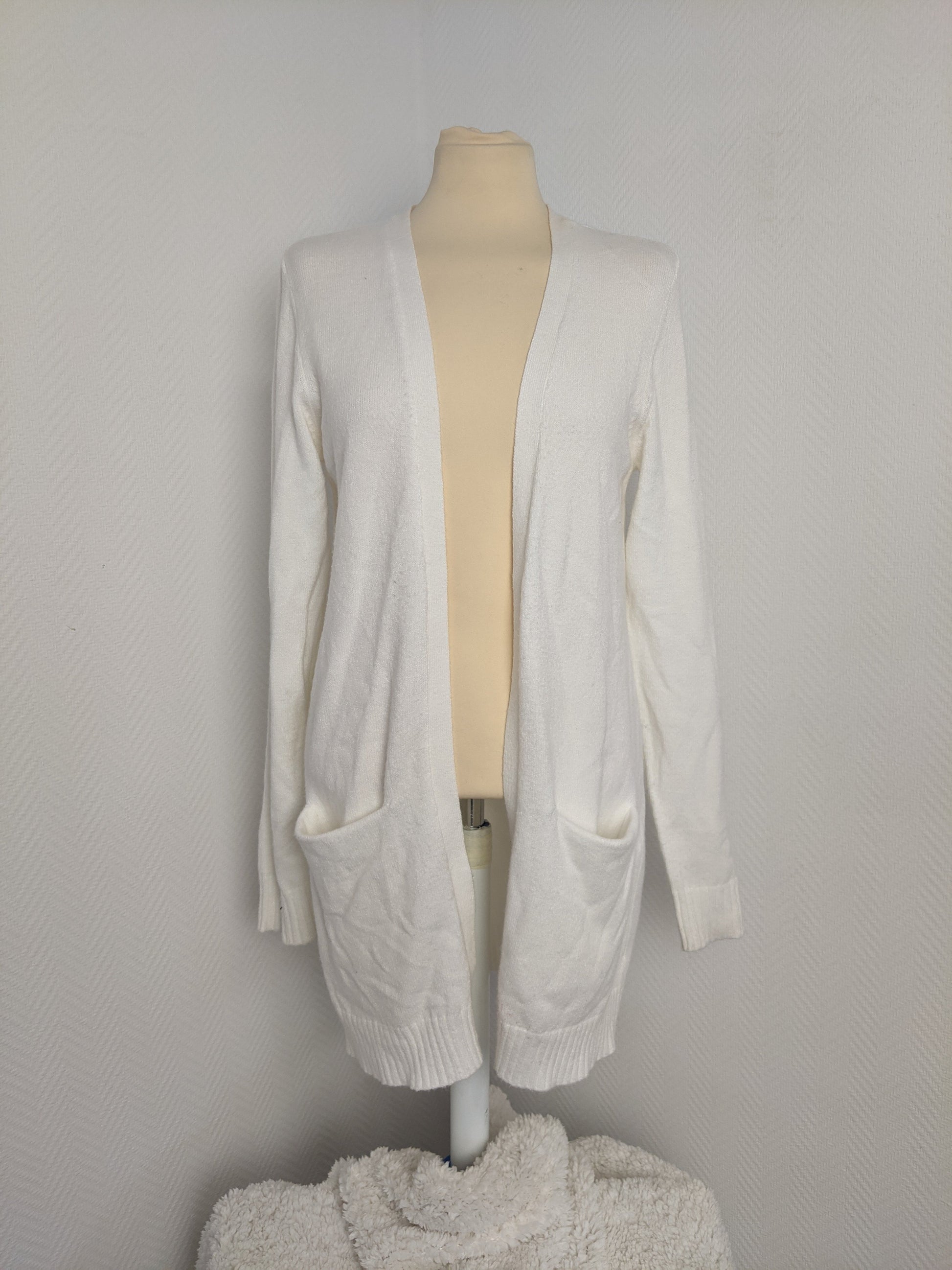 Front view of white open-front knit cardigan