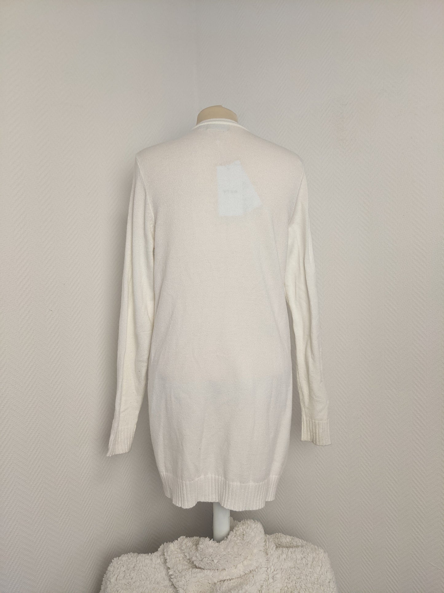 Back view of white open-front knit cardigan