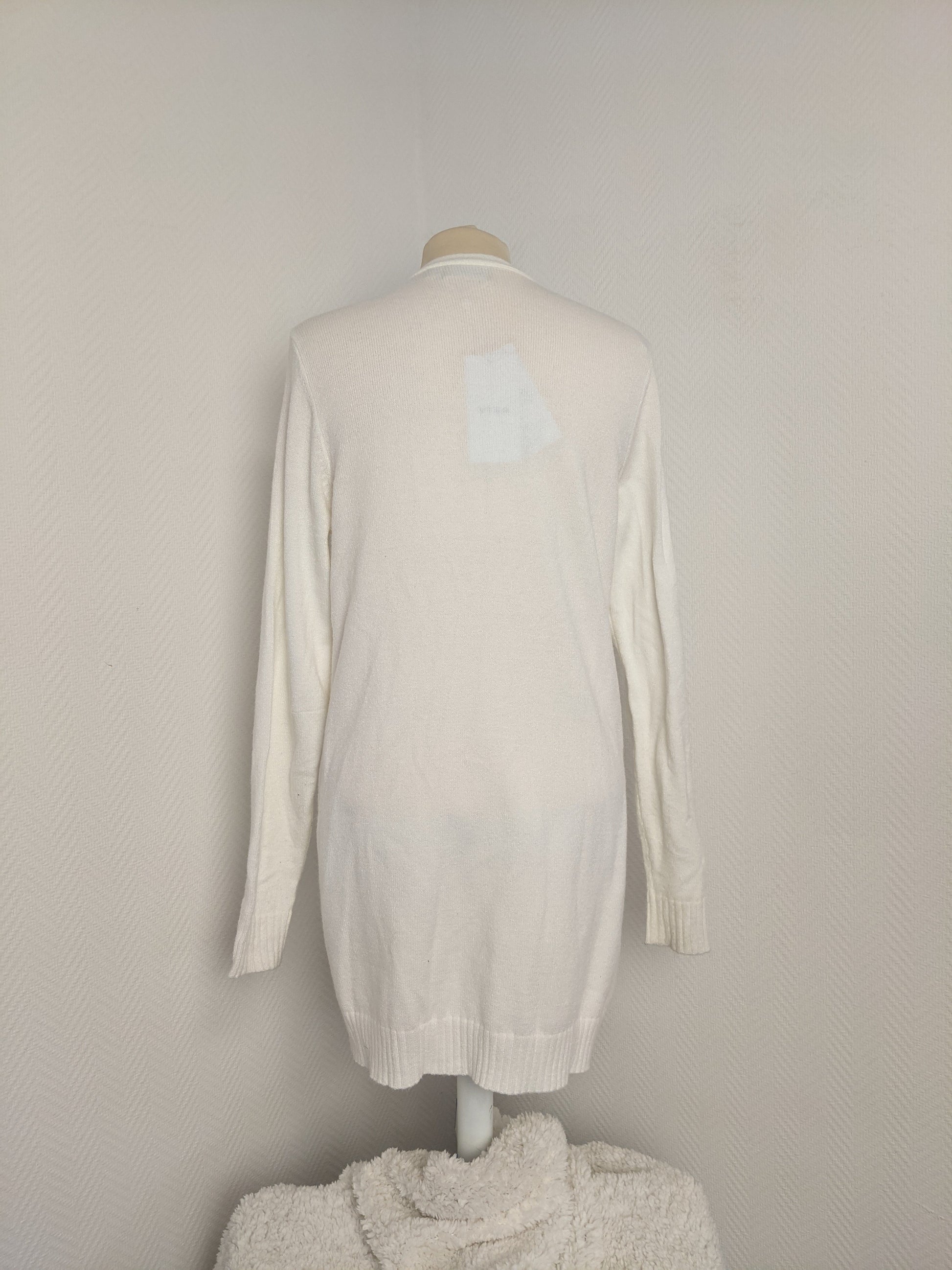Back view of white open-front knit cardigan