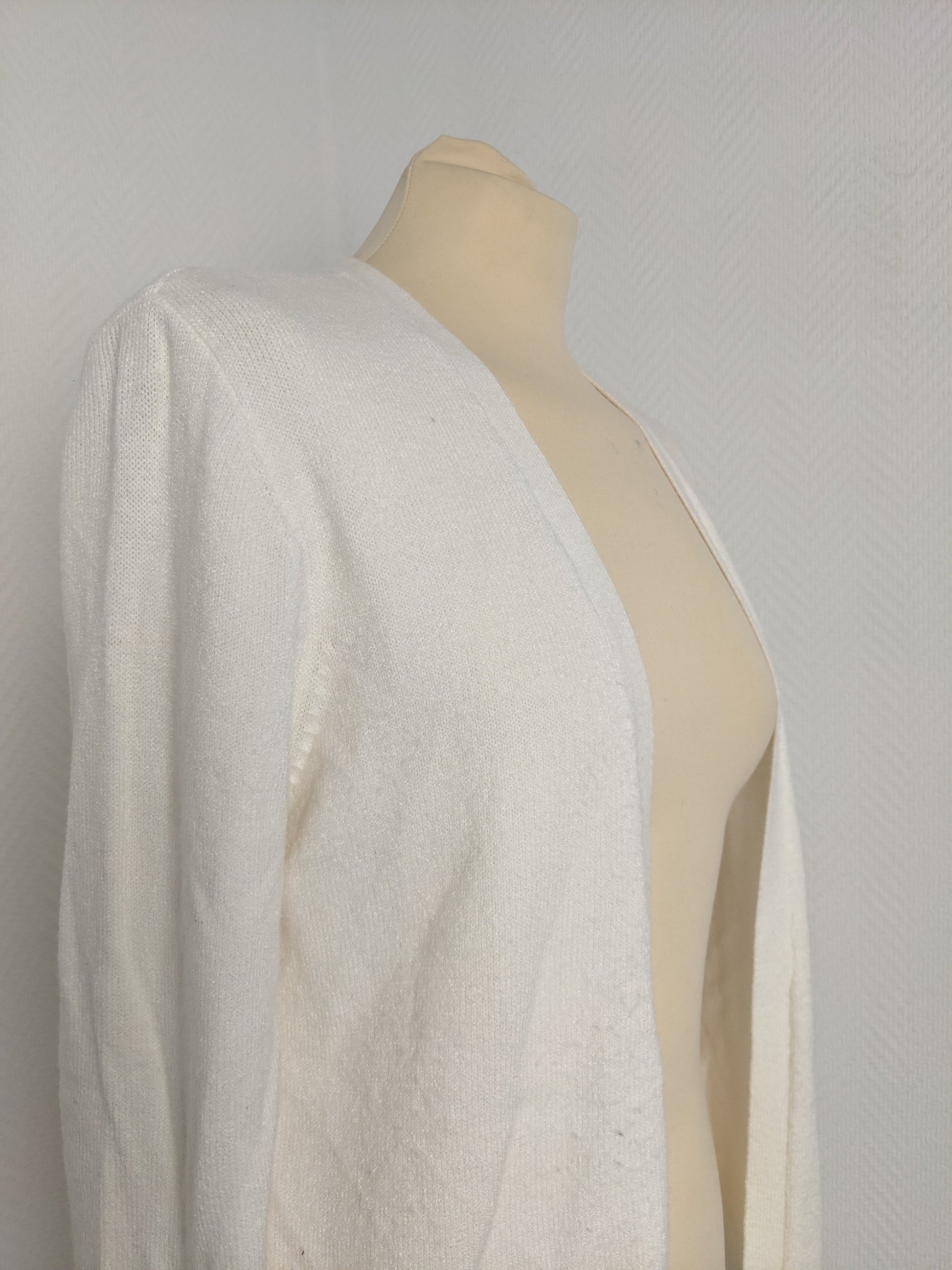 Side view of white knit cardigan