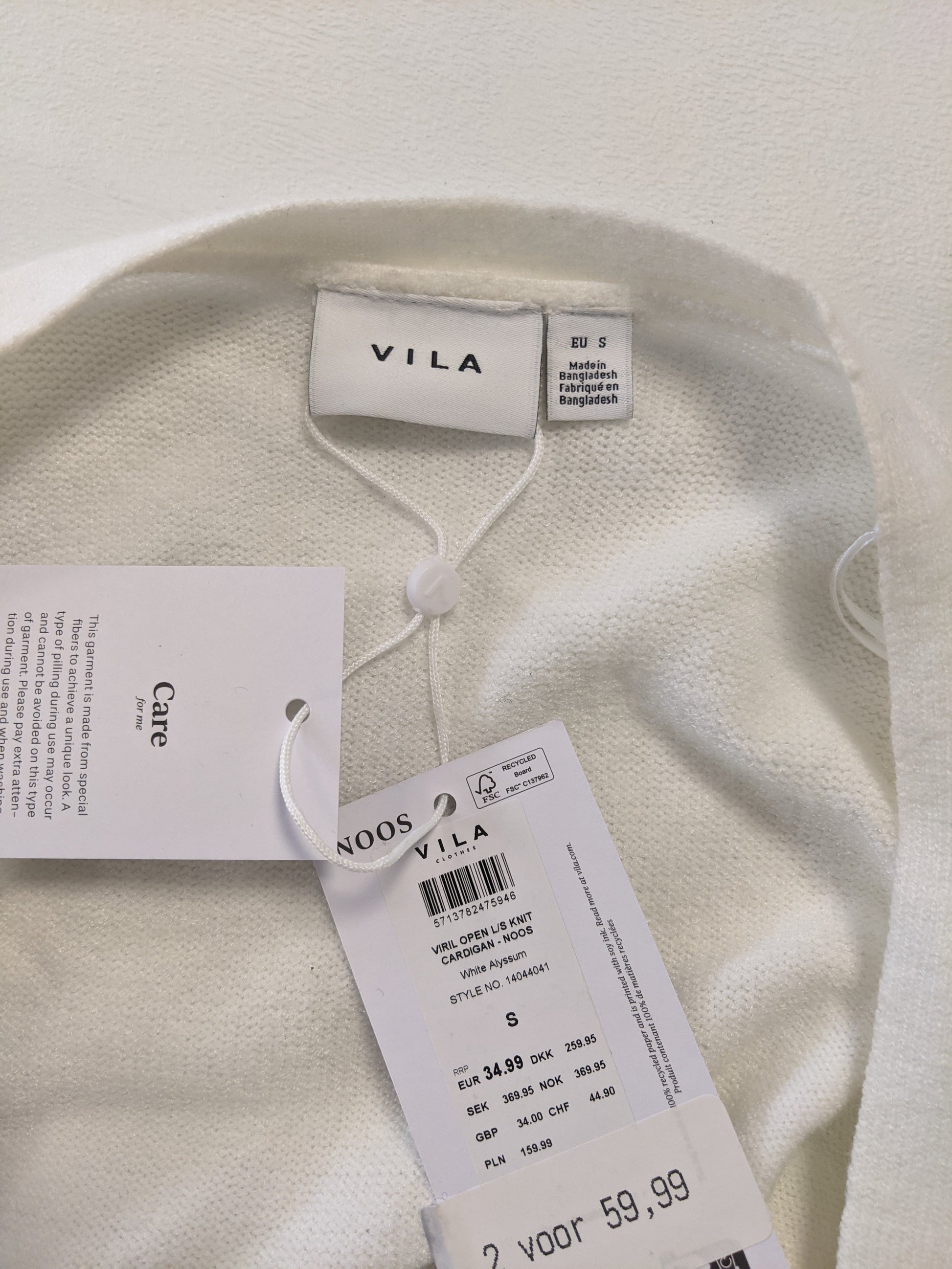 Close-up of Vila label and tag on cardigan