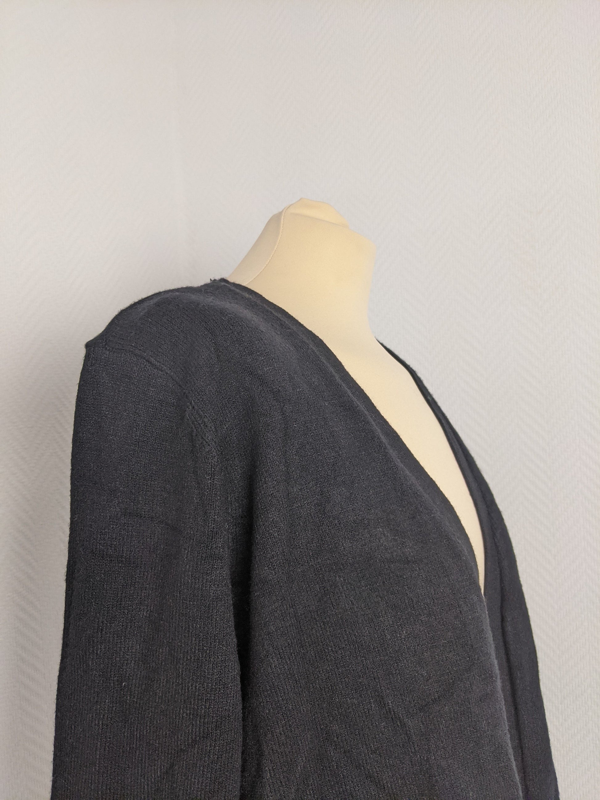 Side view of black knit cardigan