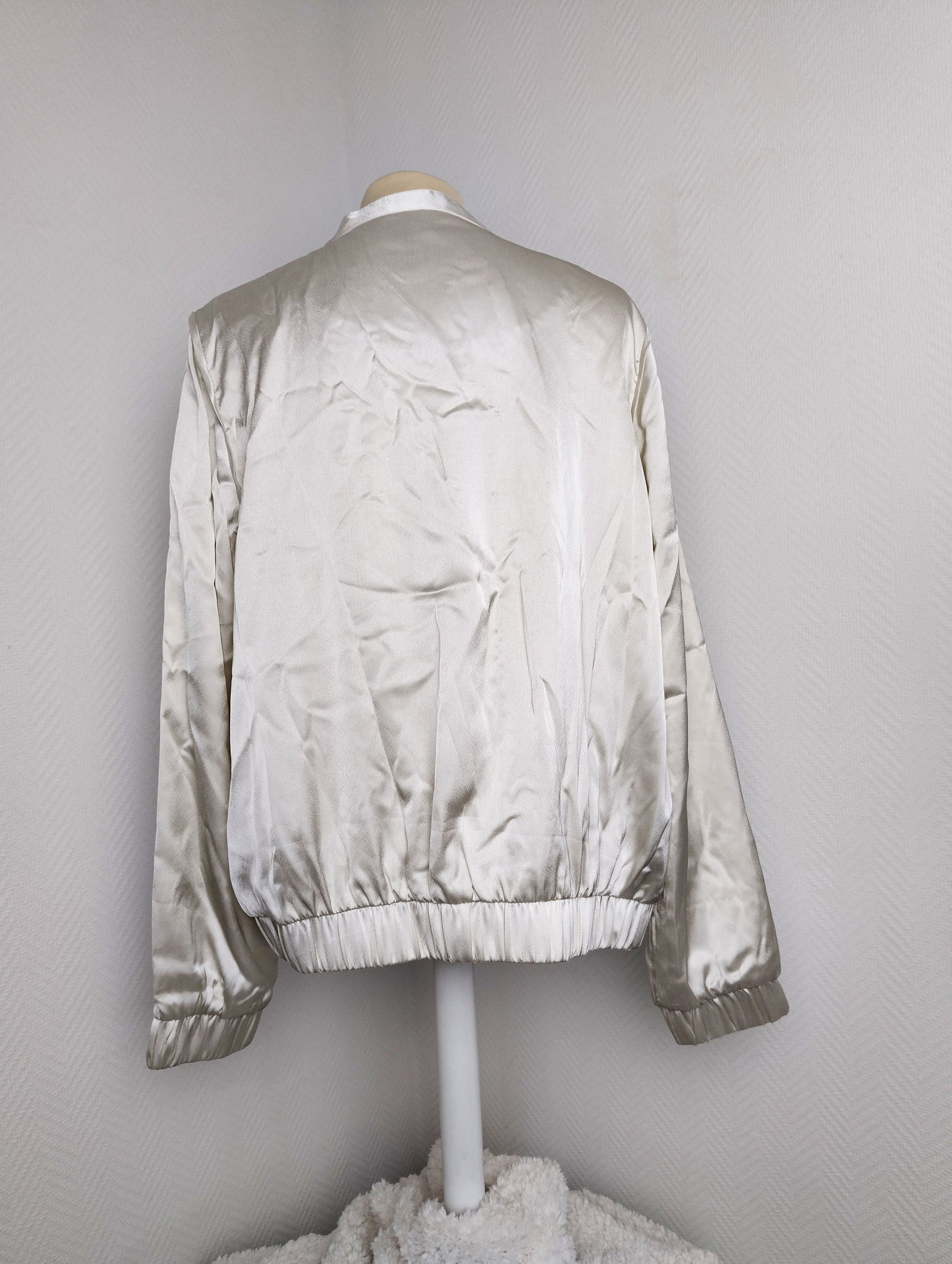 Back view of silver satin bomber jacket