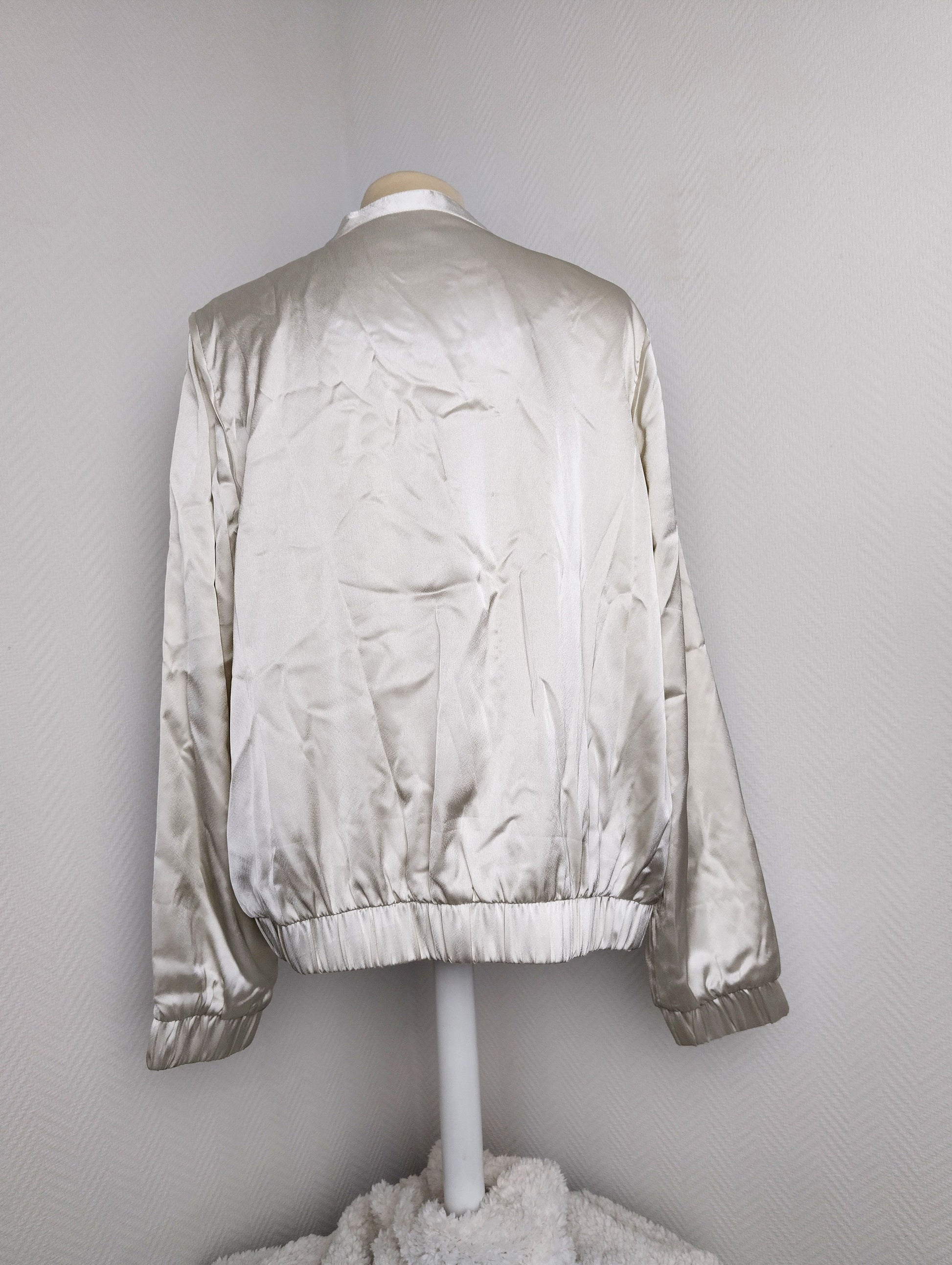 Back view of silver satin bomber jacket