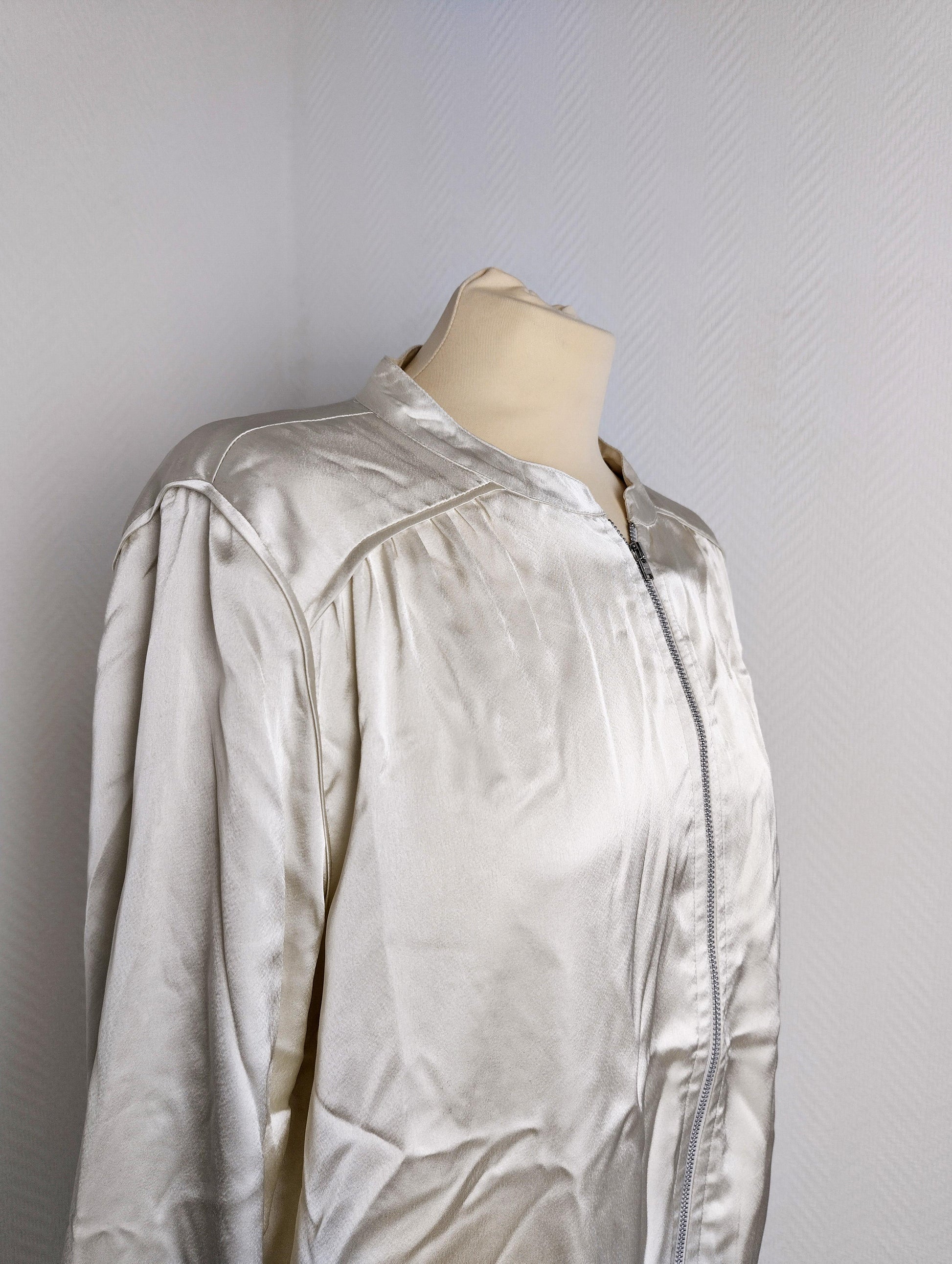 Close-up of silver satin bomber jacket