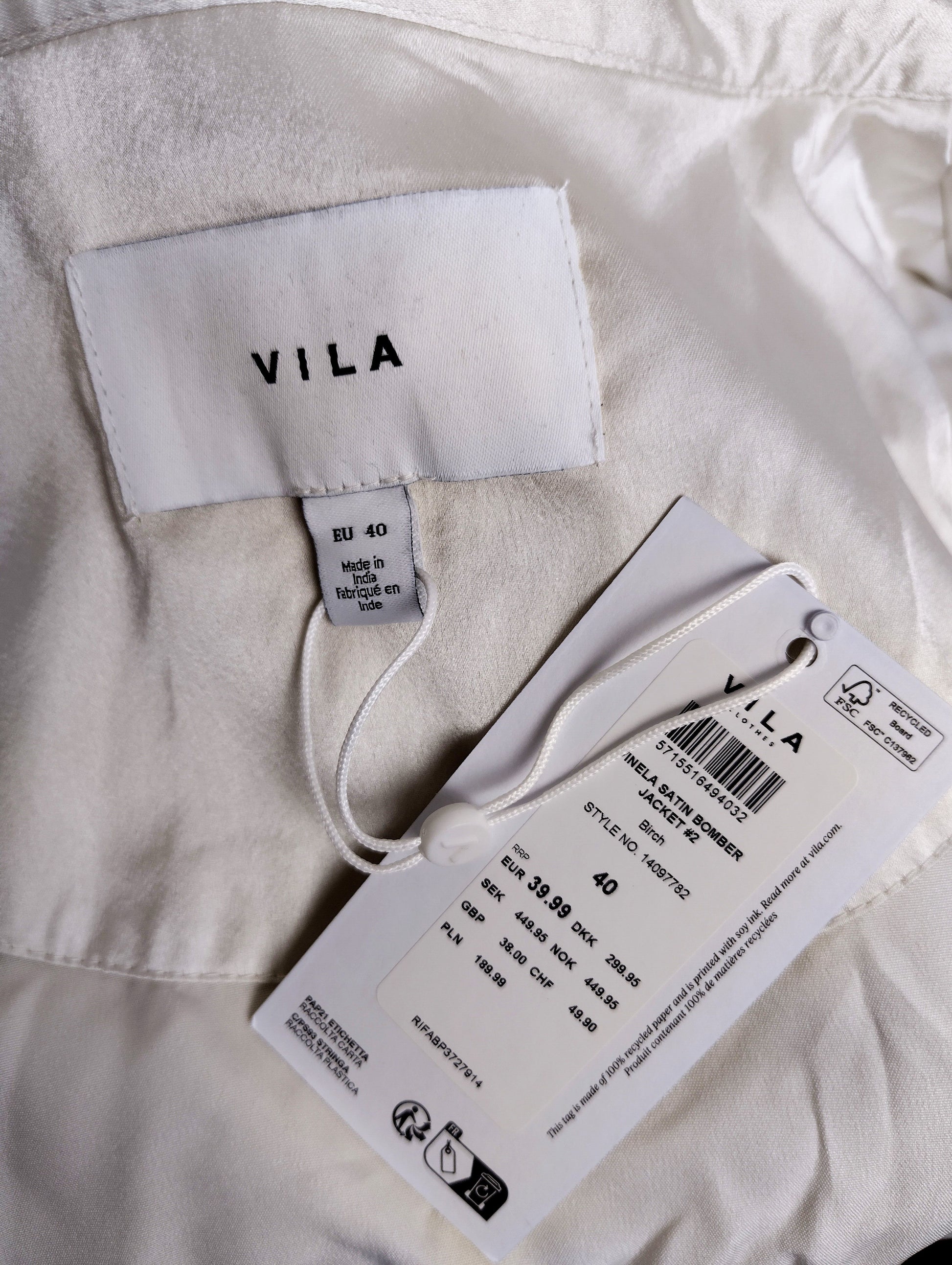 Label and tag of Vila silver satin bomber jacket