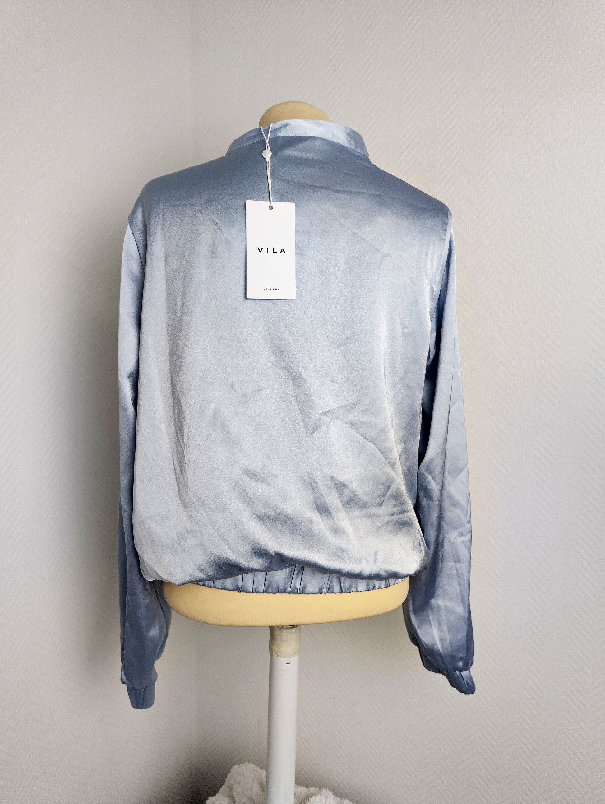 Back view of Vila light blue satin bomber jacket with tag