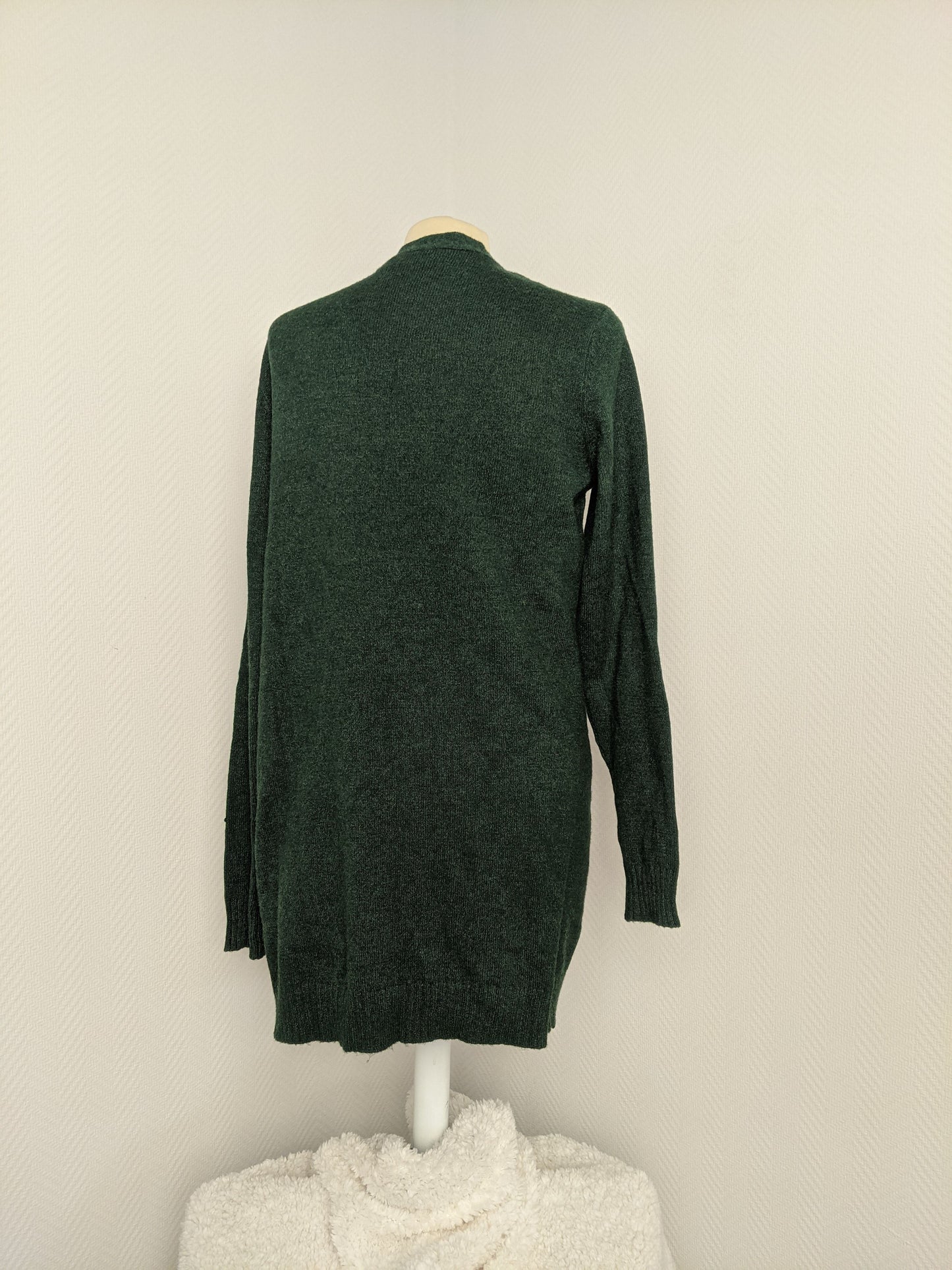 Back view of green open knit cardigan