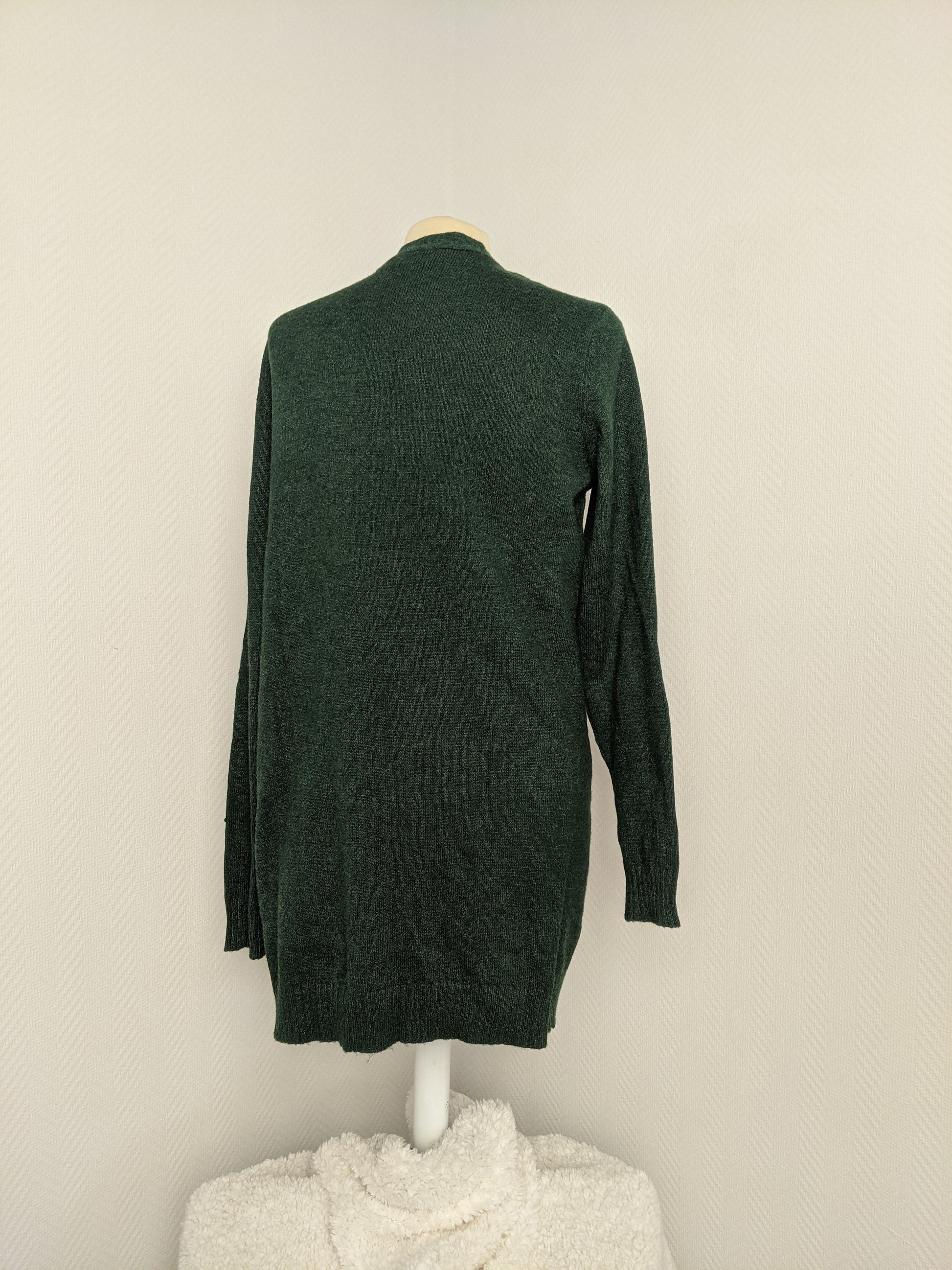 Back view of green open knit cardigan