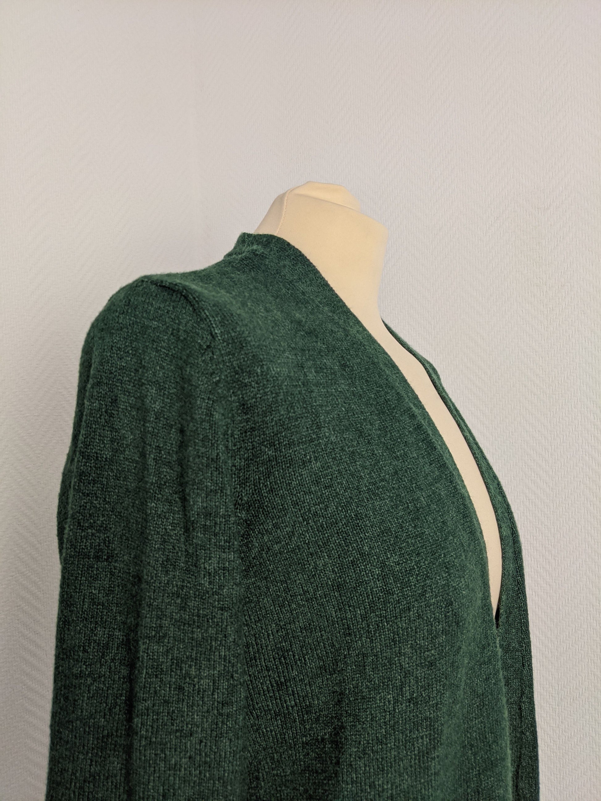 Side view of green open knit cardigan