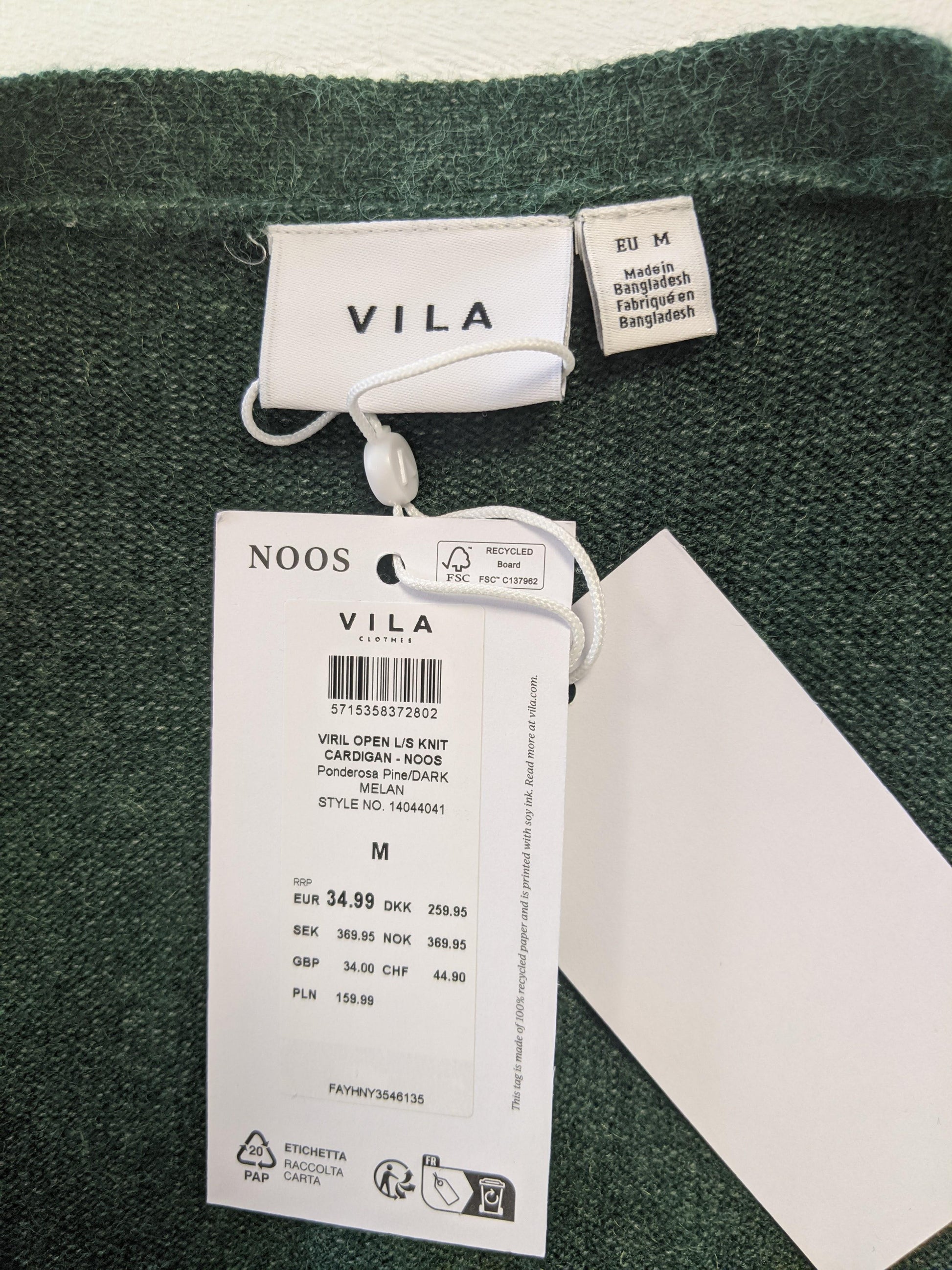 Tag on green open knit cardigan indicating brand and size