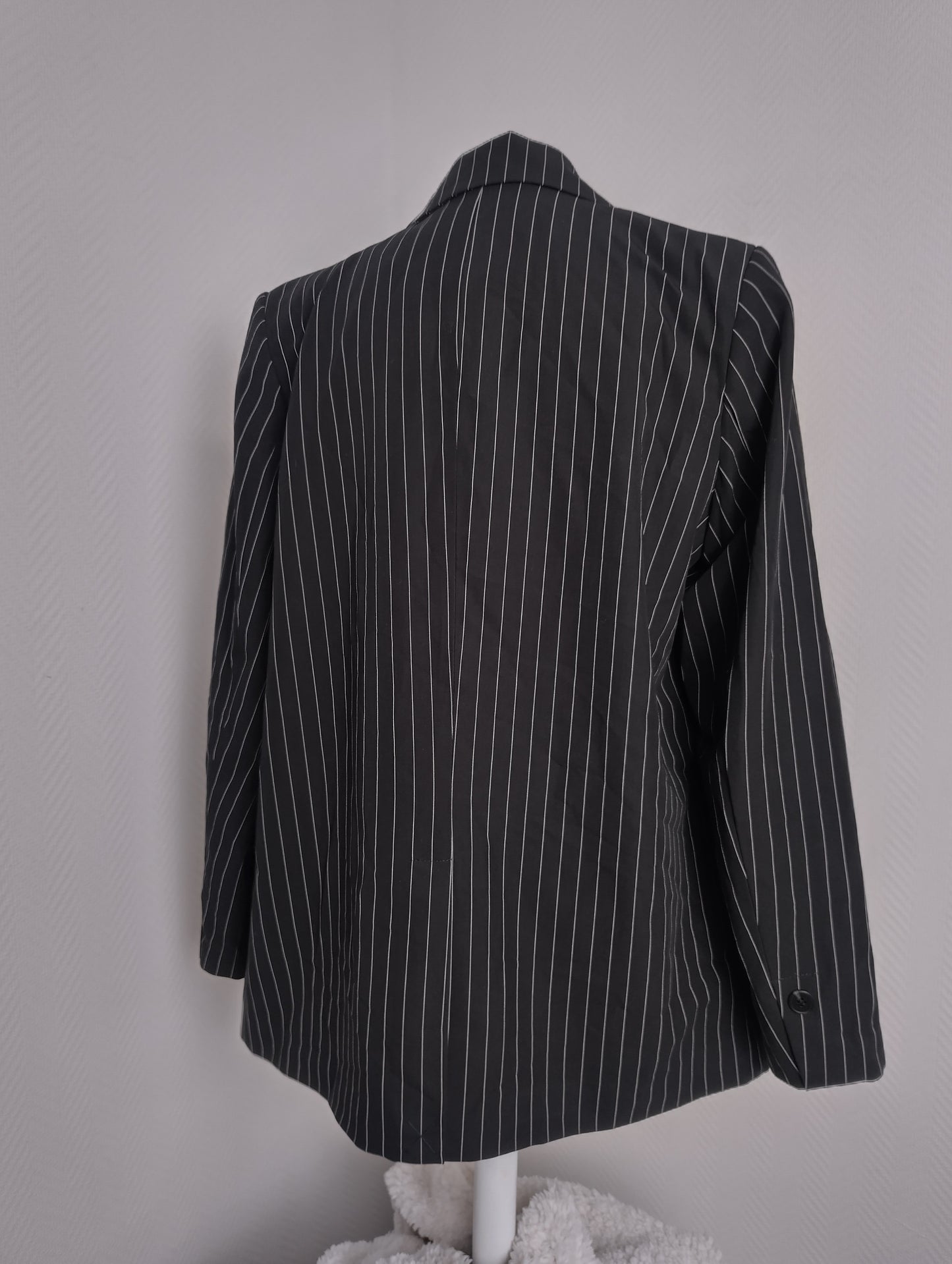Back view of black pinstripe blazer