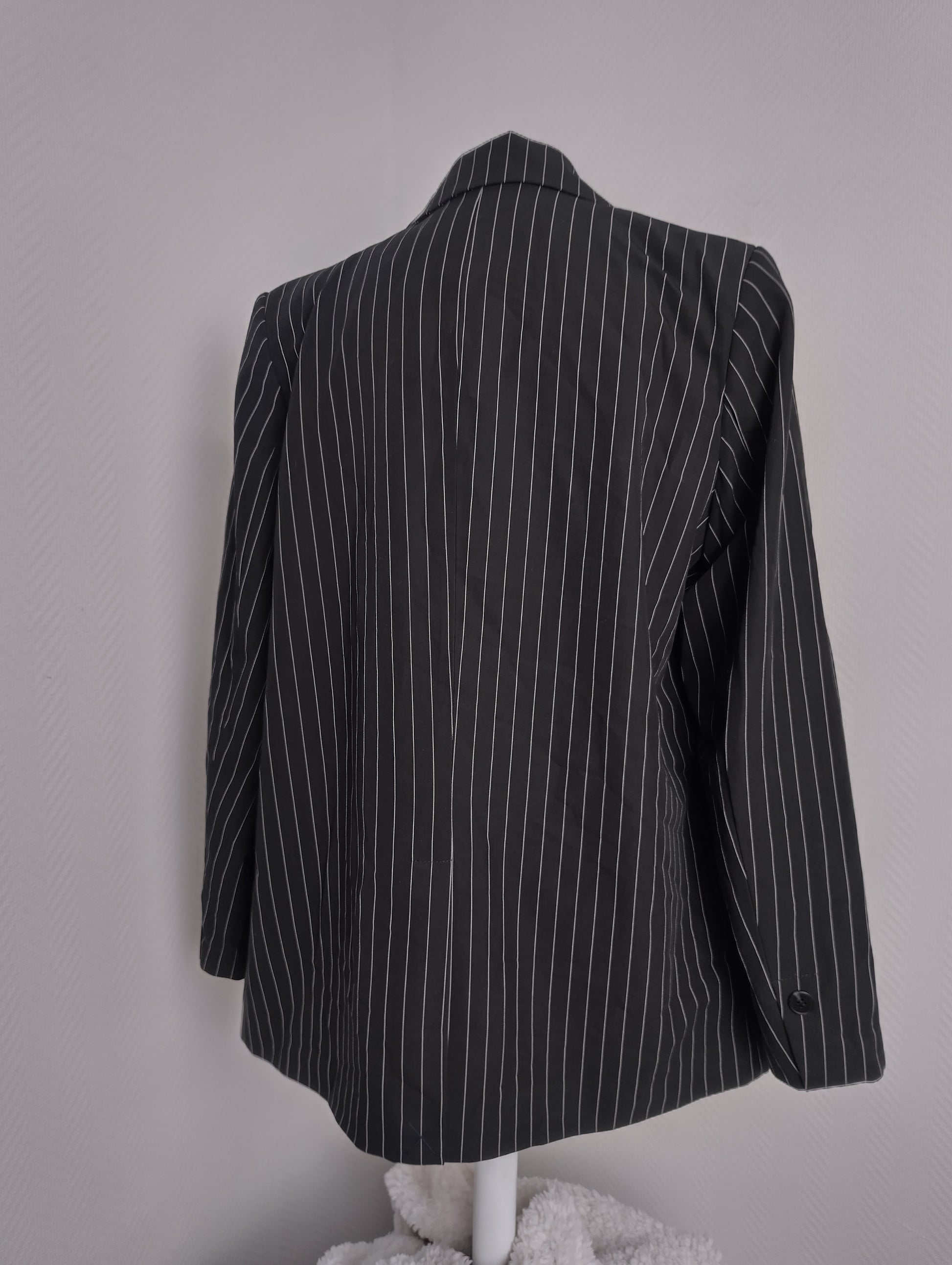 Back view of black pinstripe blazer