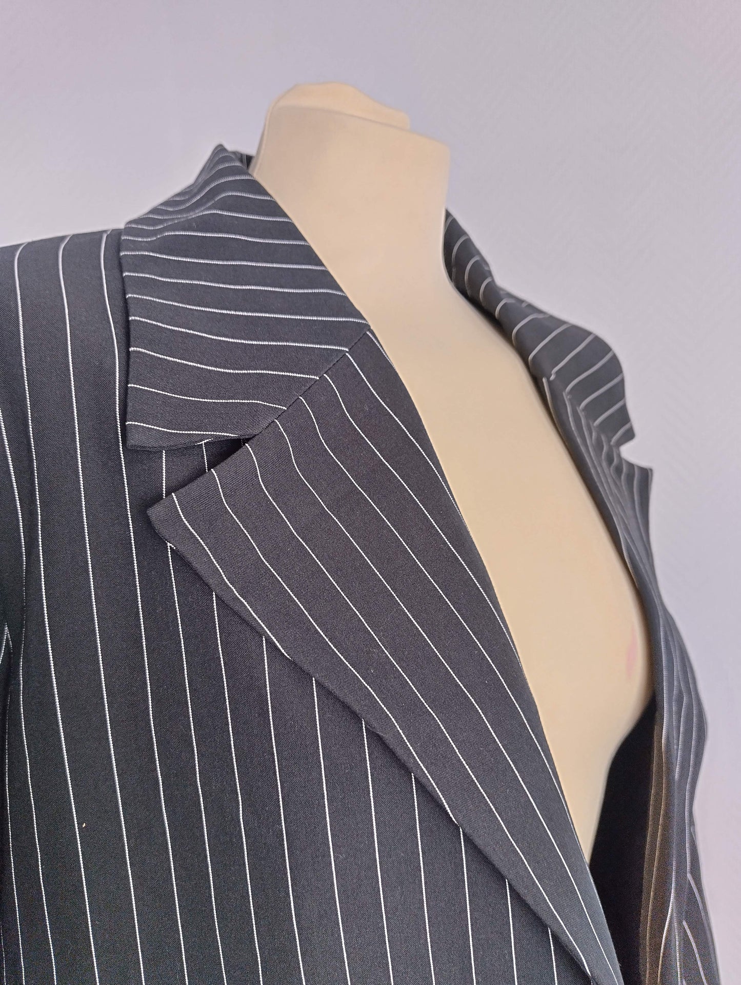 Close-up of collar and lapel on black pinstripe blazer