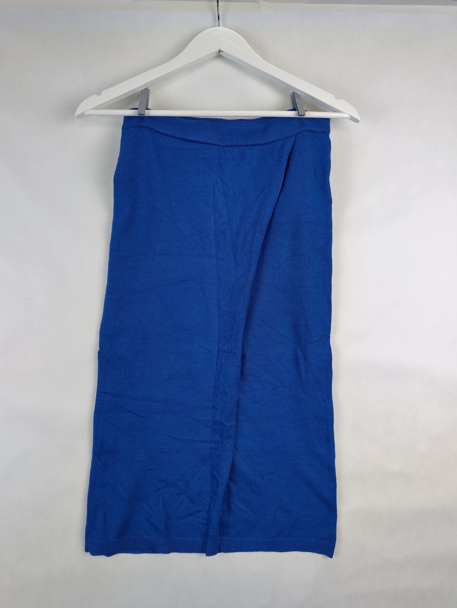 Back view of a blue midi skirt on a hanger
