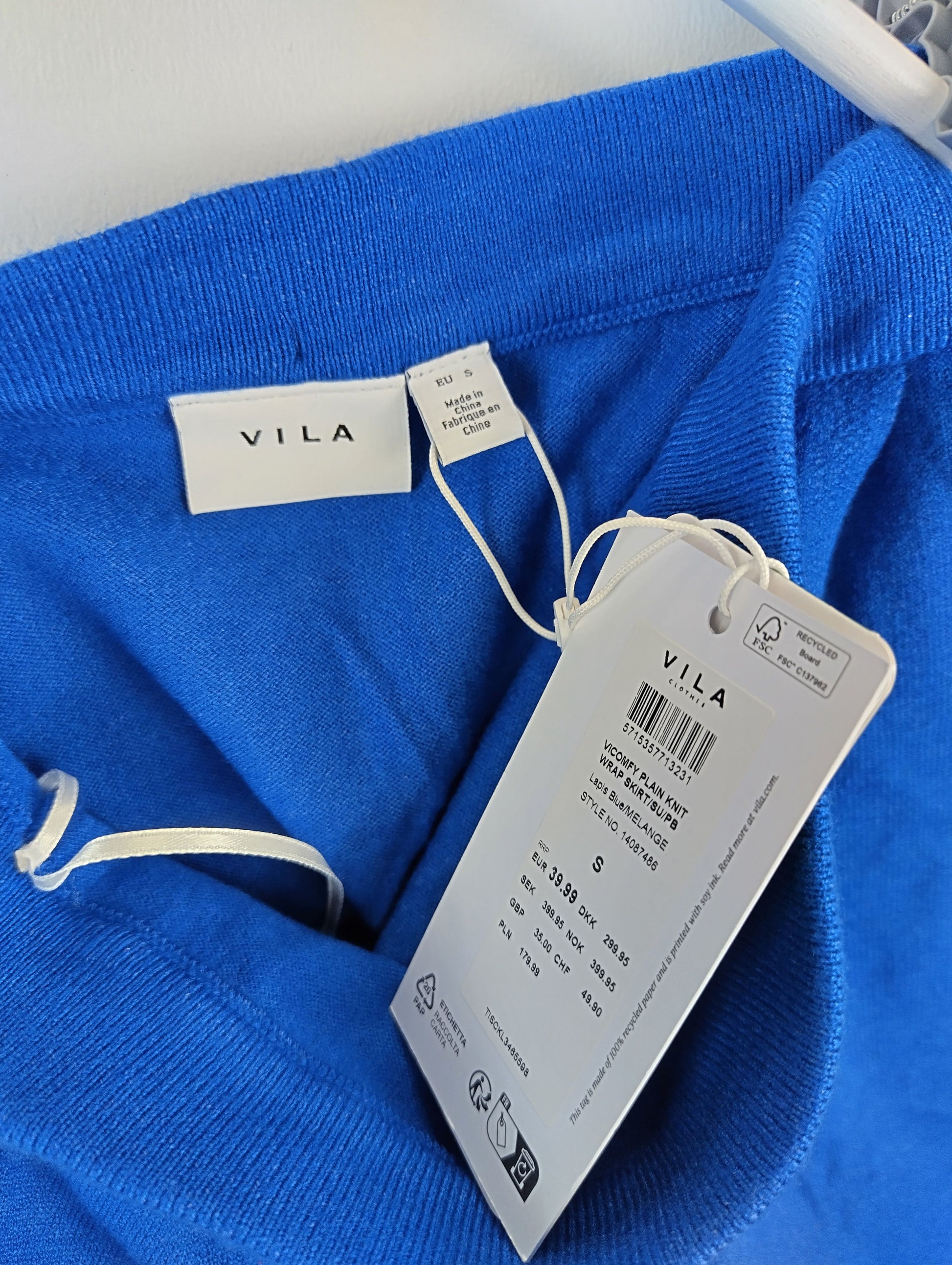 Close-up of Vila label and tag on blue skirt