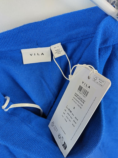 Close-up of Vila label and tag on blue skirt