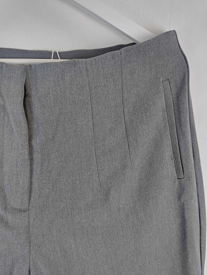 Side detail of grey pants on hanger