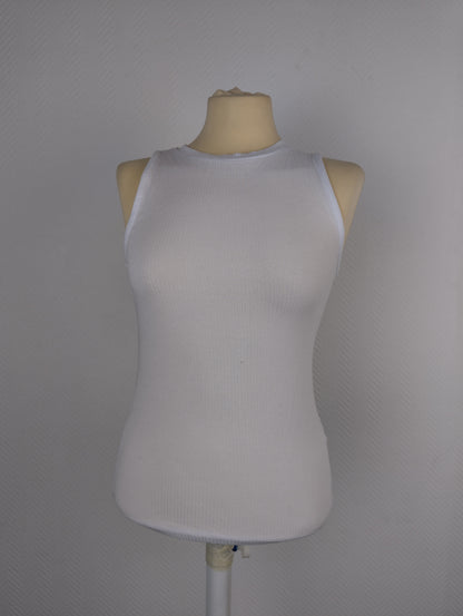 Front view of white ribbed tank top on mannequin
