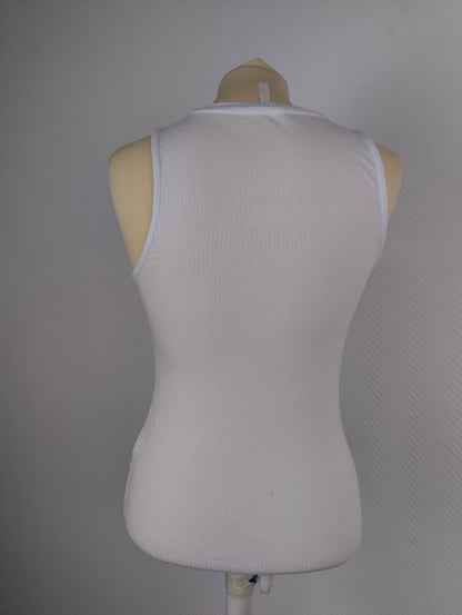 Back view of white ribbed tank top on mannequin
