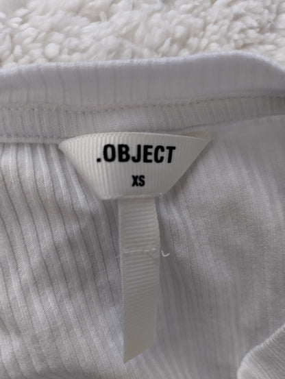 Label showing brand and size of the white ribbed tank top