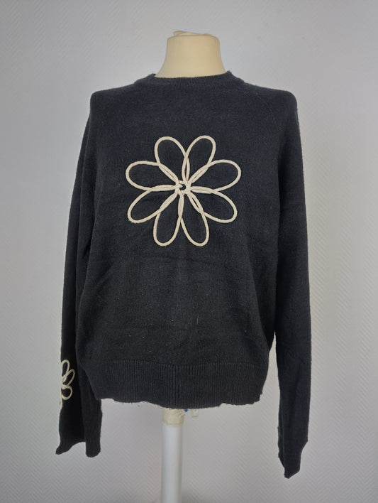 Front view of black sweater with floral design
